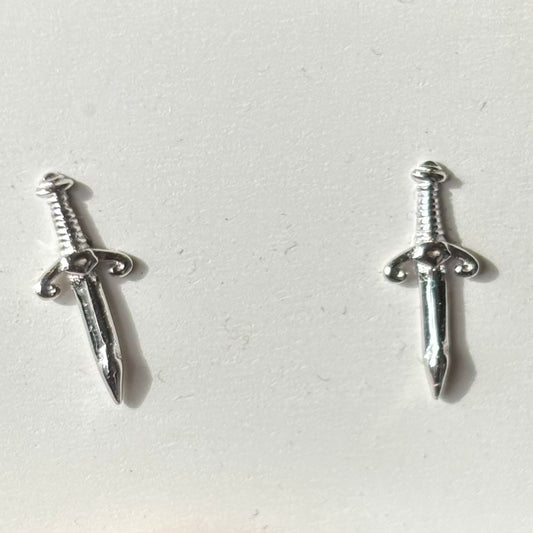 Silver sword-shaped earrings on a light gray background