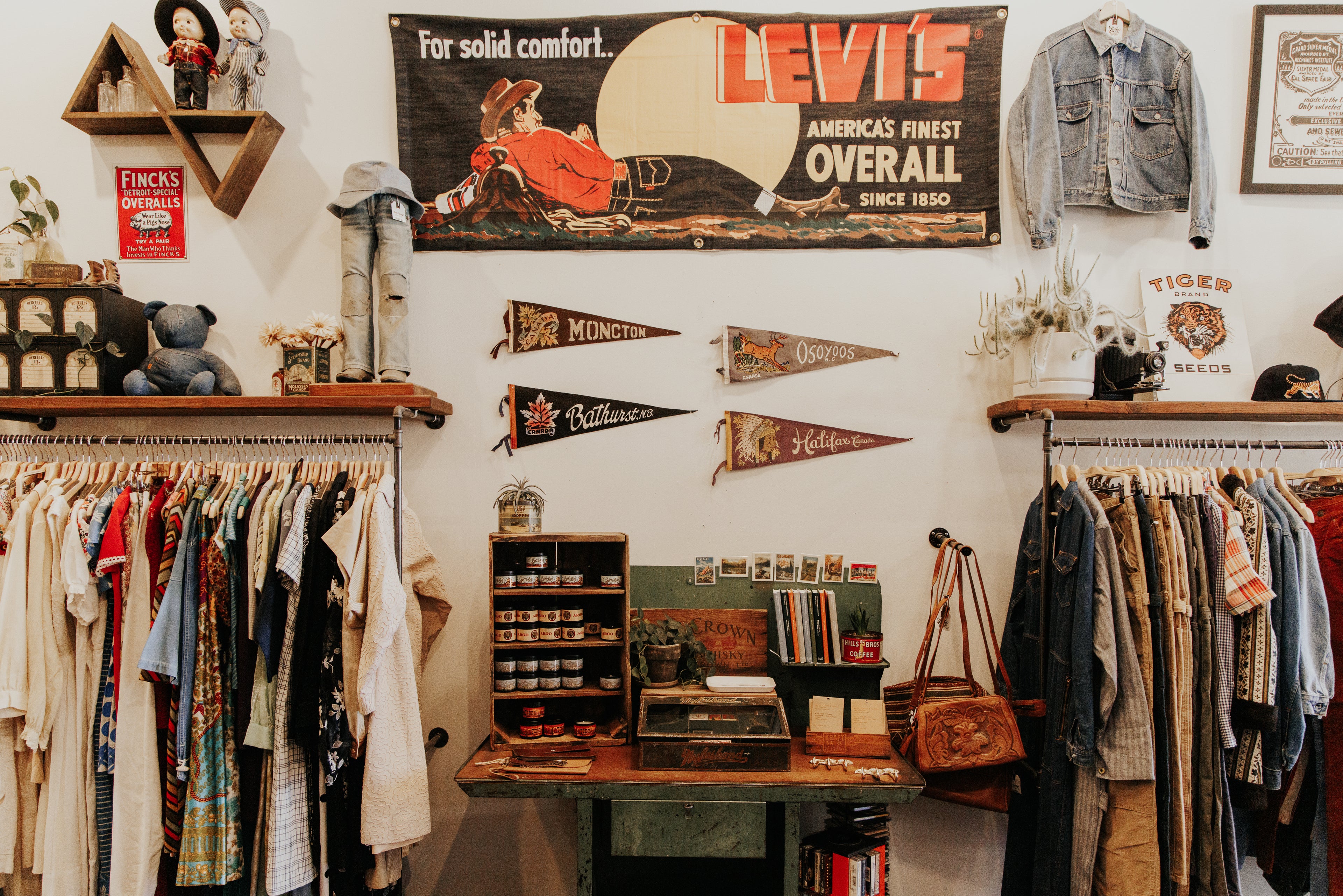 L Lovely Vintage clothing store interior with Levi's sign and shelves displaying an array of items both modern and vintage.