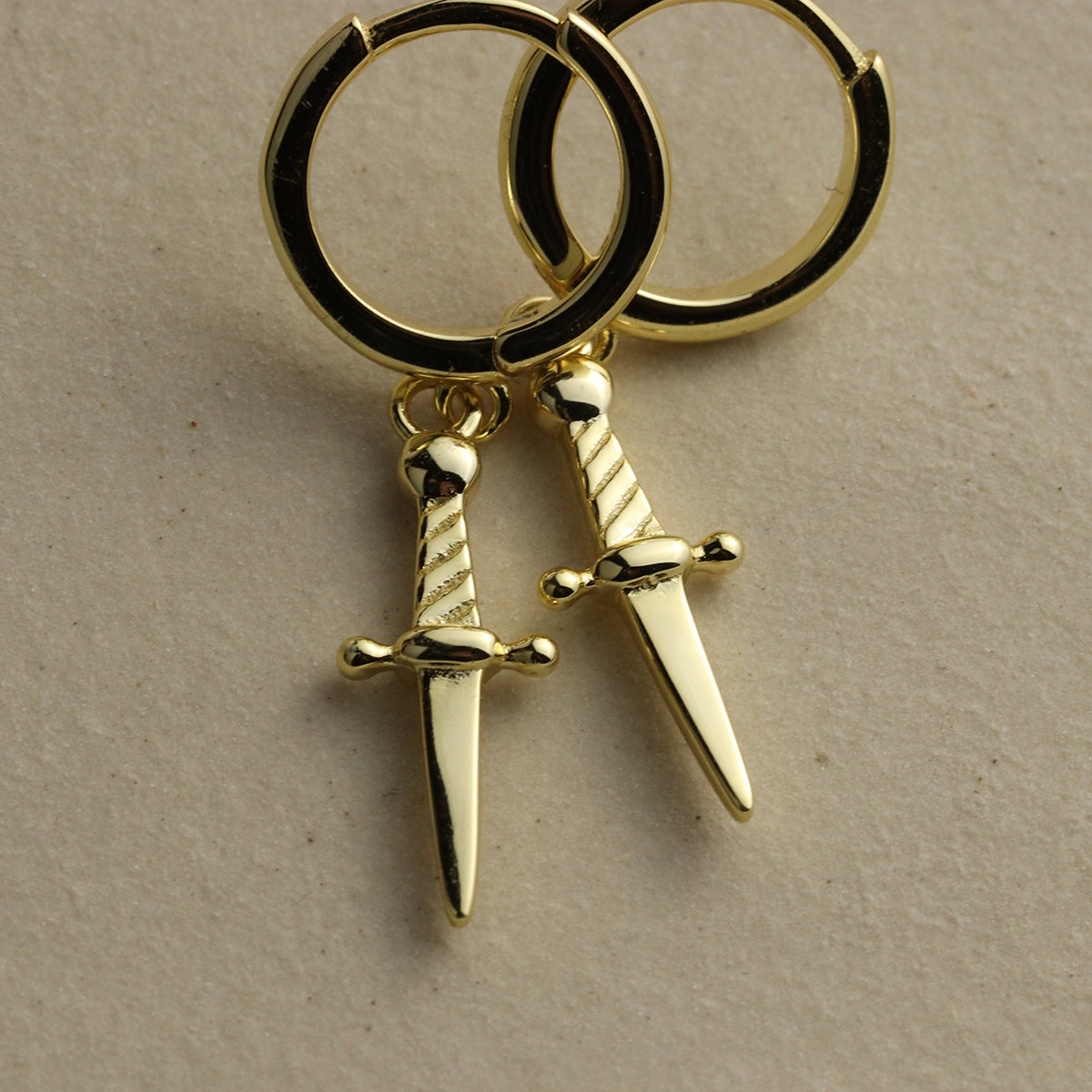 Mini daggers hoop earrings in gold vermeil over sterling silver with a snap close.
