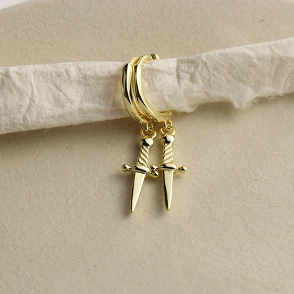 Mini daggers hoop earrings in gold vermeil over sterling silver with a snap close. Earrings are styled over a piece of fiber.