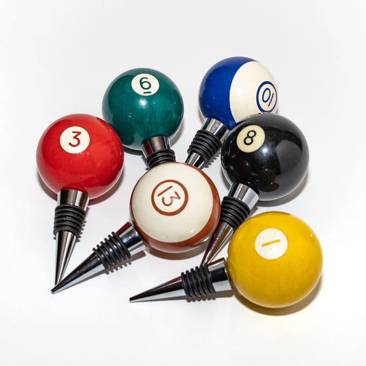 Set of billiard ball wine bottle stoppers on a white background